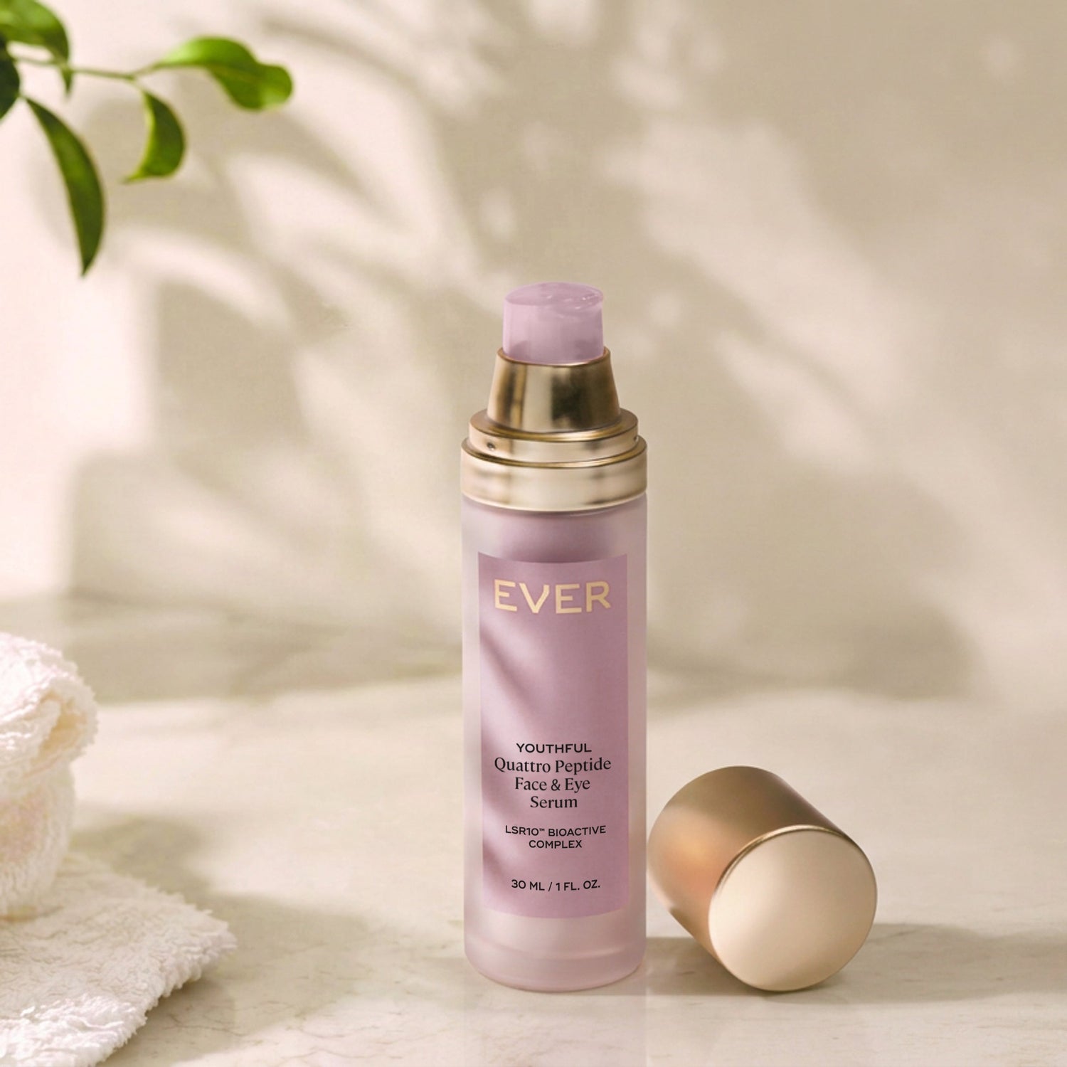 EVER Cosmetics Overnight Peptide Face & Eye Lotion in a frosted lavender bottle with gold accents, shown with its cap off on a marble surface.